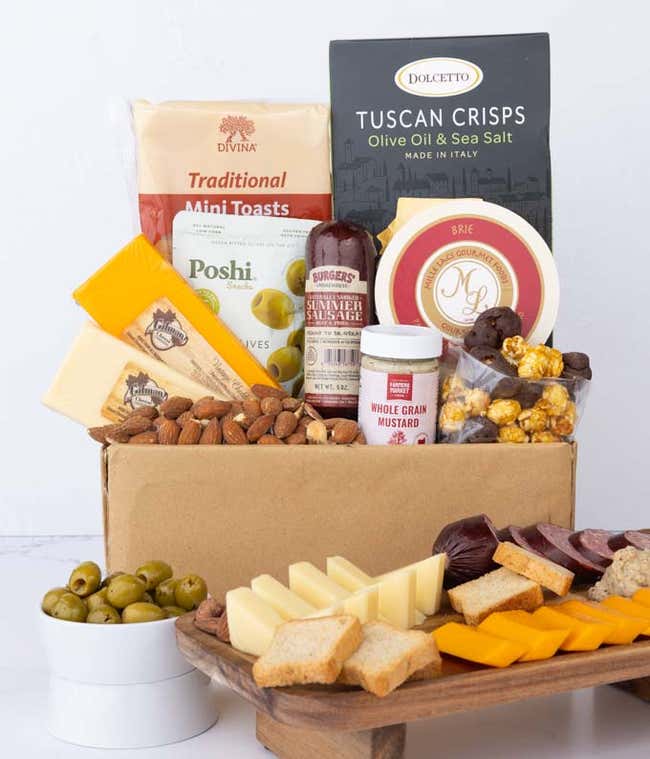 A gourmet charcuterie gift set featuring Tuscan crisps, focaccia crackers, smoked cheddar, garlic &amp; onion cheese, brie spread, olives, mustard, almonds, chocolate-covered popcorn, and summer sausage.  Perfect for entertaining.